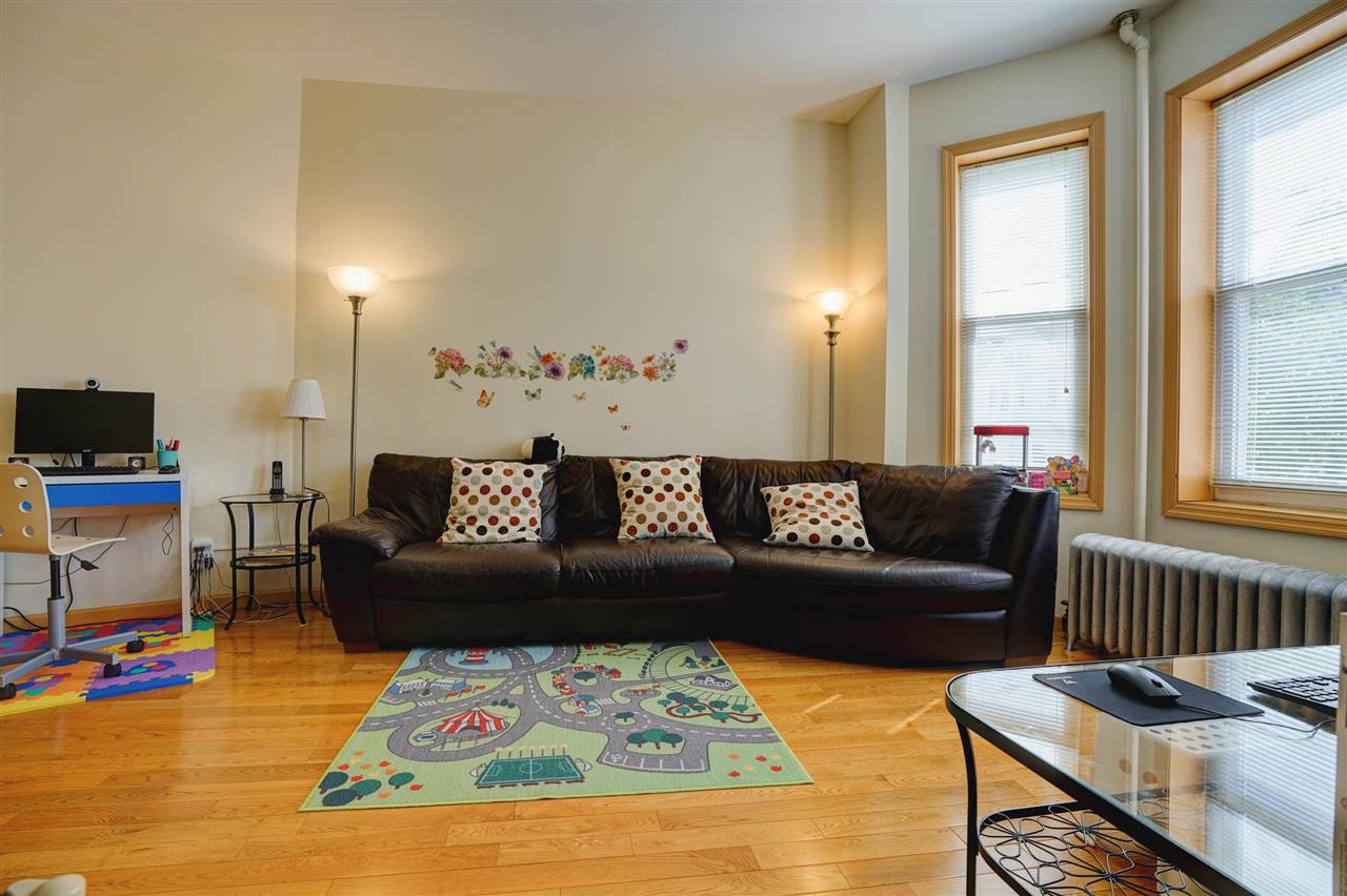 527 North 3rd Street East Newark, NJ 07029 - Photo 4 of 25 a living room with furniture and a window
