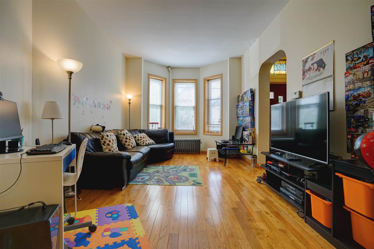 527 North 3rd Street East Newark, NJ 07029 - Photo 5 of 25 a living room with furniture and a flat screen tv