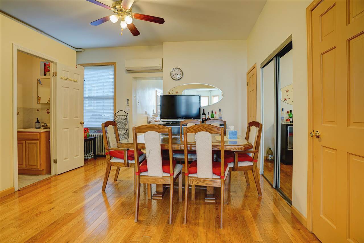 527 North 3rd Street East Newark, NJ 07029 - Photo 7 of 25 a view of a dining room with furniture and wooden floor