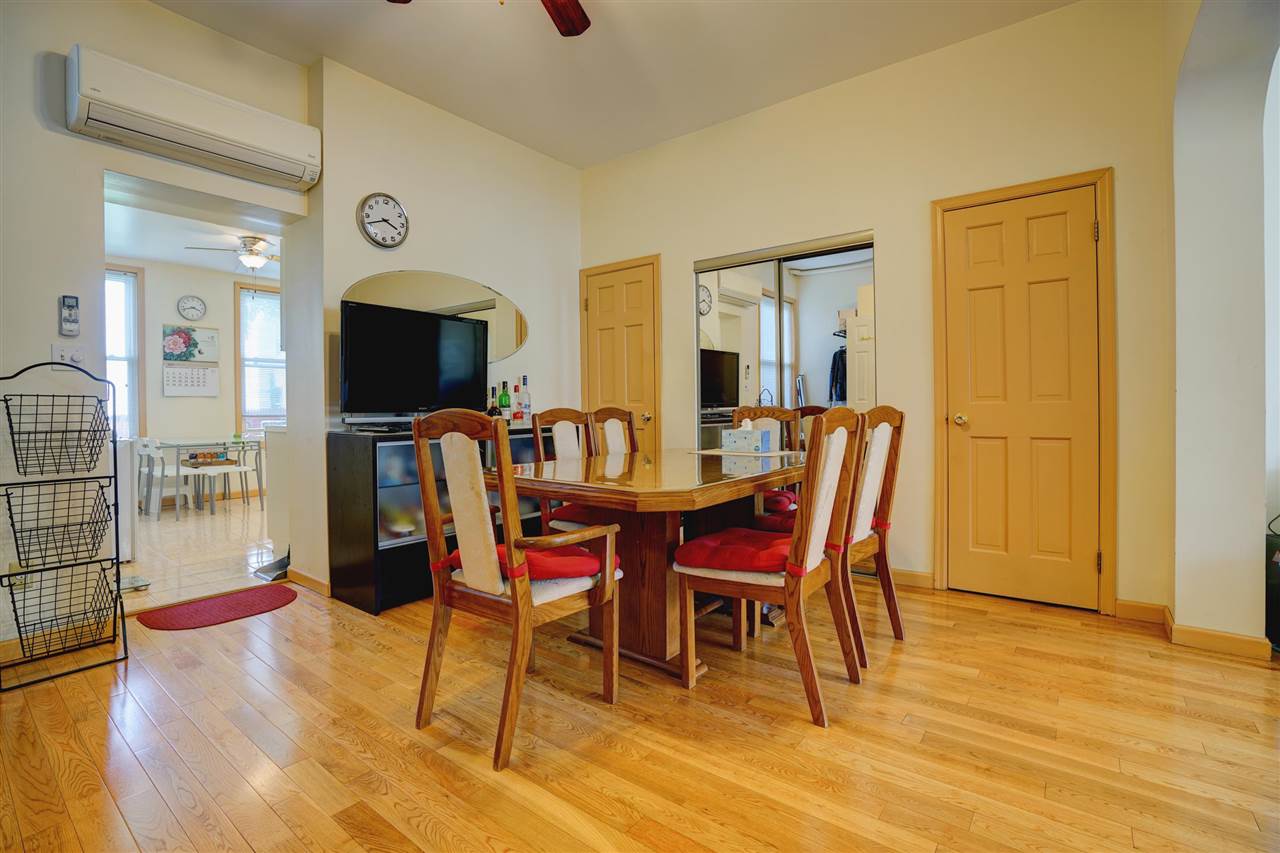 527 North 3rd Street East Newark, NJ 07029 - Photo 8 of 25 a view of a dining room with furniture and a chandelier