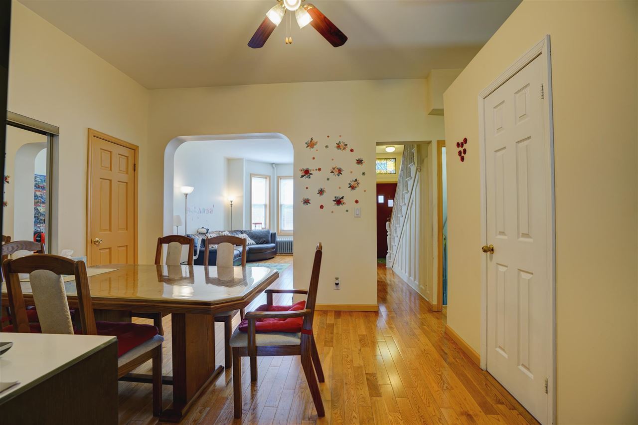 527 North 3rd Street East Newark, NJ 07029 - Photo 9 of 25 a dining room with furniture and wooden floor