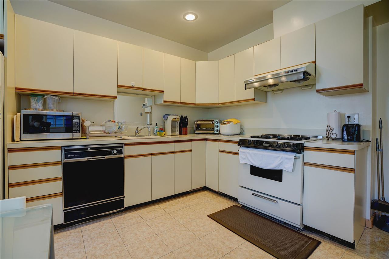 527 North 3rd Street East Newark, NJ 07029 - Photo 10 of 25 a kitchen with stainless steel appliances granite countertop a stove and white cabinets