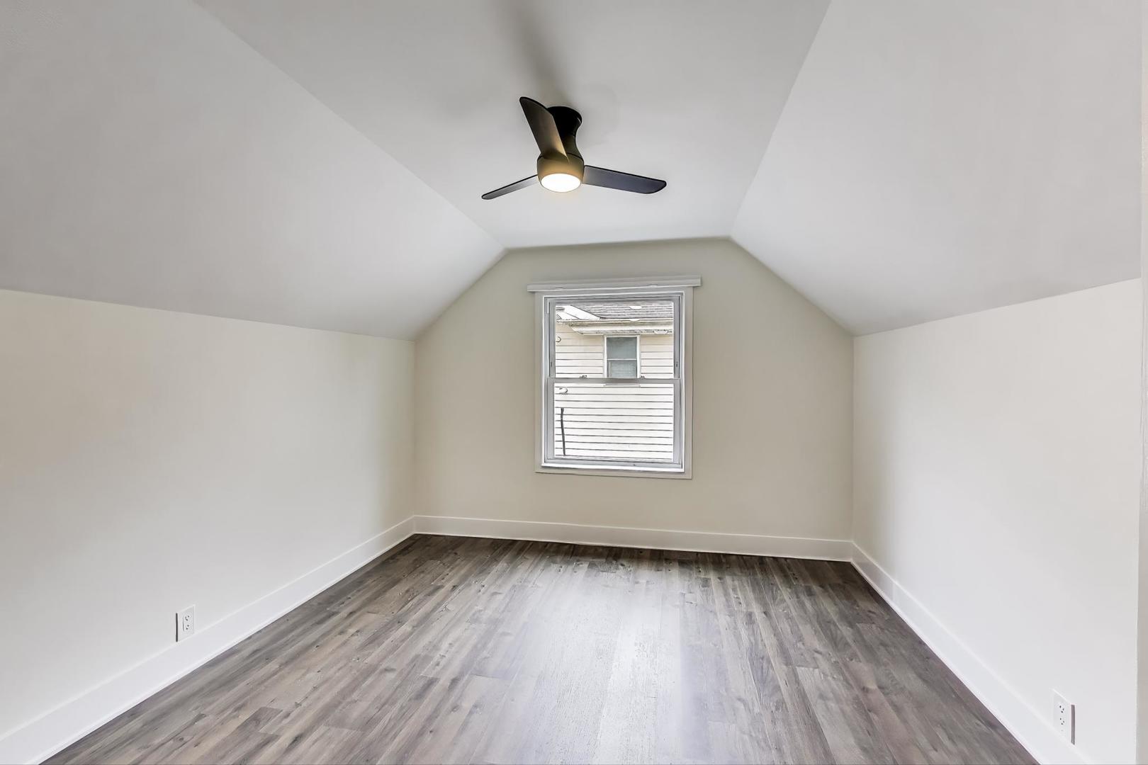 139 South Quentin Road Palatine, IL 60067 - Photo 11 of 23 an empty room with wooden floor ceiling fan and window