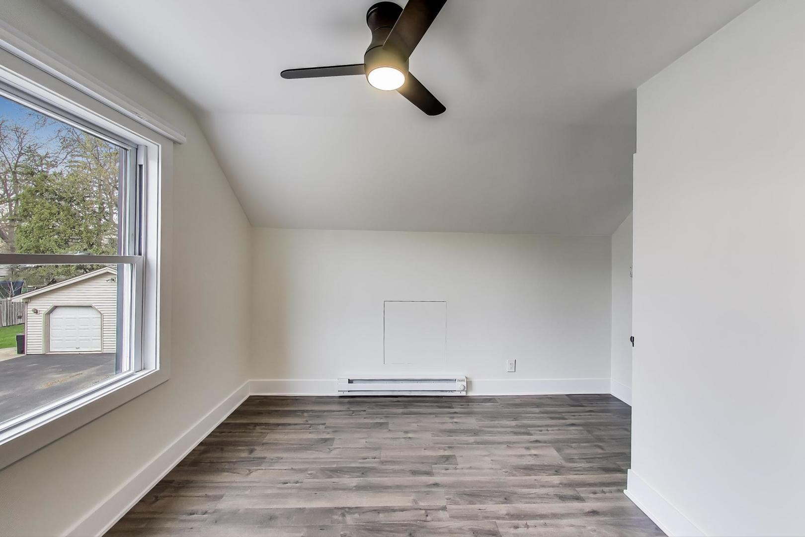 139 South Quentin Road Palatine, IL 60067 - Photo 14 of 23 a view of an empty room with wooden floor and a window