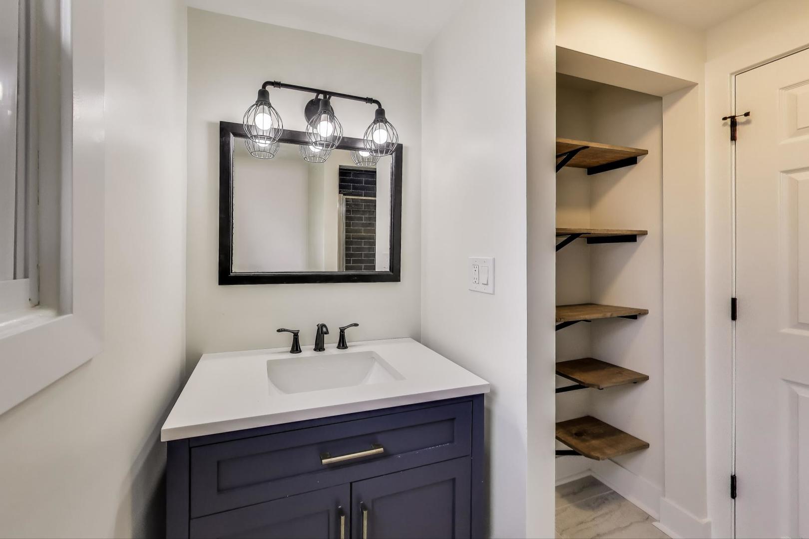 139 South Quentin Road Palatine, IL 60067 - Photo 15 of 23 a bathroom with a sink and a mirror