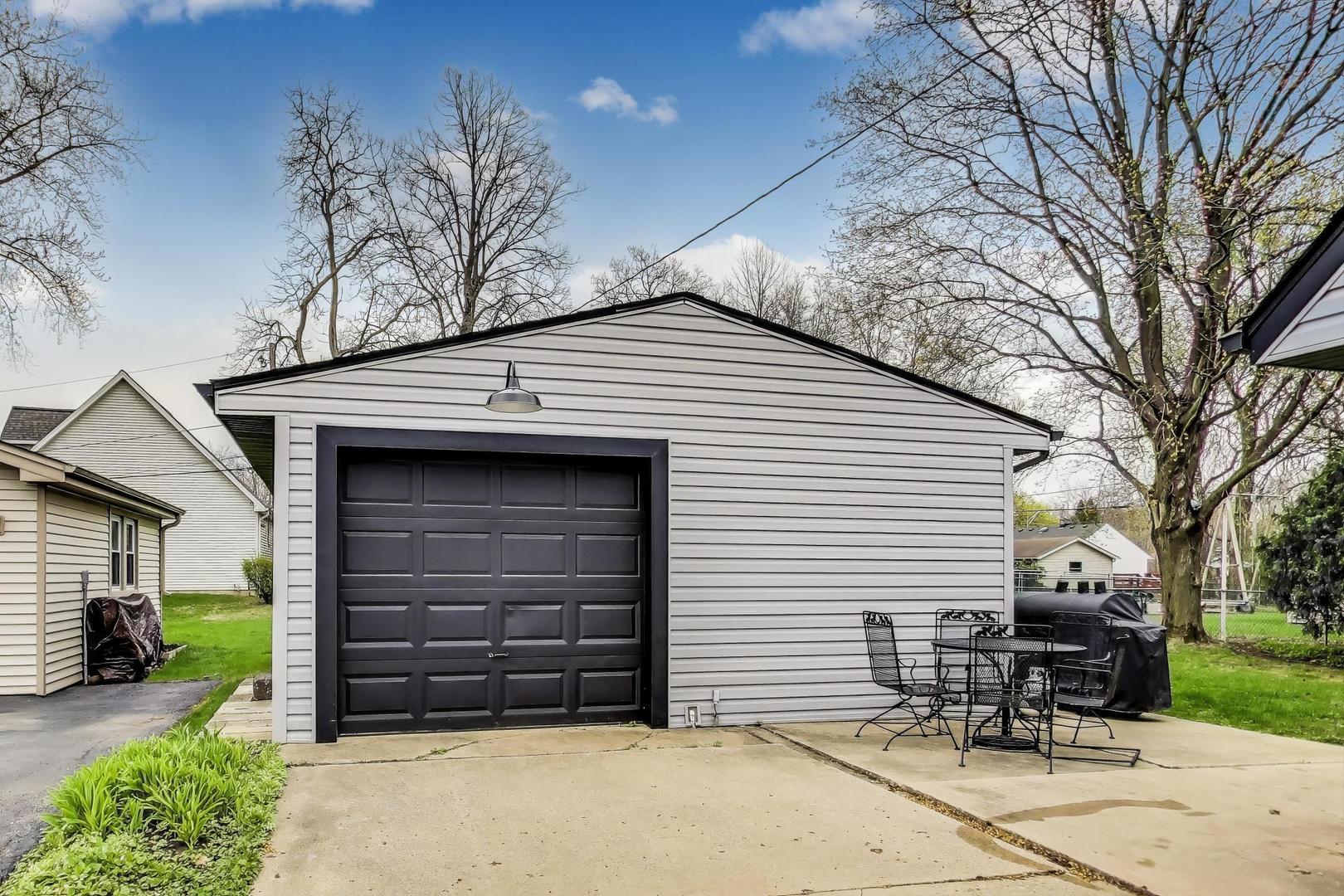 139 South Quentin Road Palatine, IL 60067 - Photo 17 of 23 a front view of a house with a chair and table