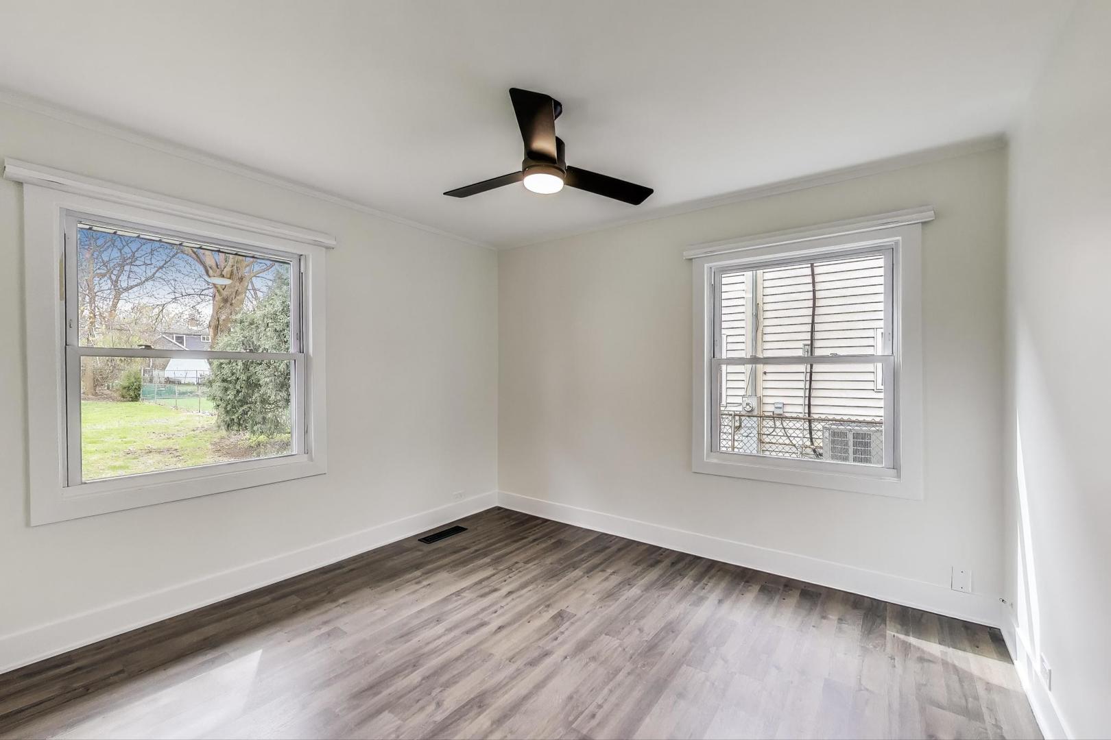 139 South Quentin Road Palatine, IL 60067 - Photo 6 of 23 a view of an empty room with wooden floor and a window