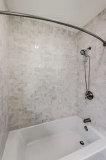 a bathroom with a shower and a bath tub