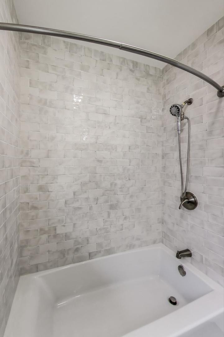 139 South Quentin Road Palatine, IL 60067 - Photo 9 of 23 a bathroom with a shower and a bath tub