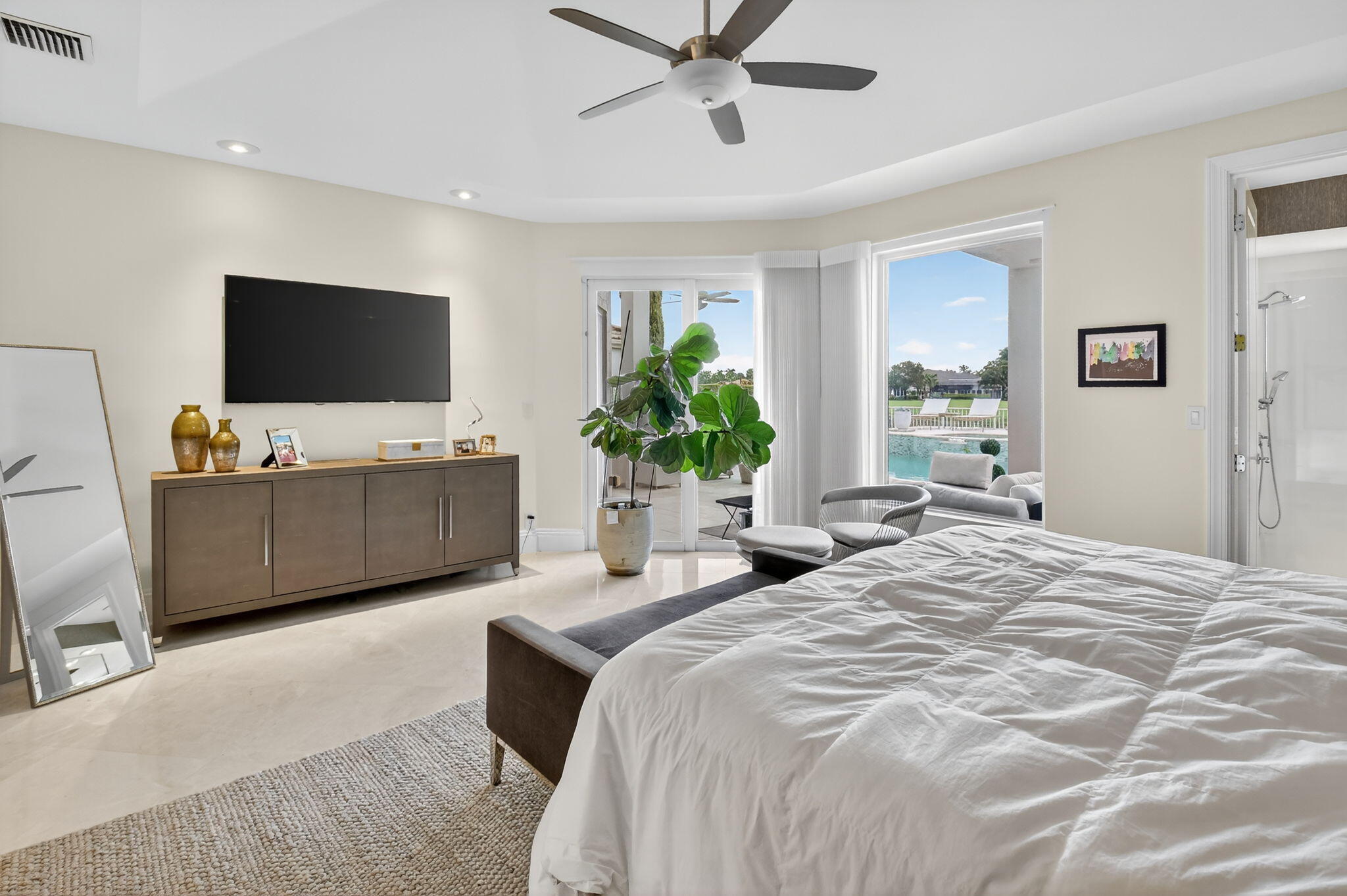2563 Northwest 63rd Street Boca Raton, FL 33496 - Photo 27 of 65 a bedroom with a bed and a flat screen tv