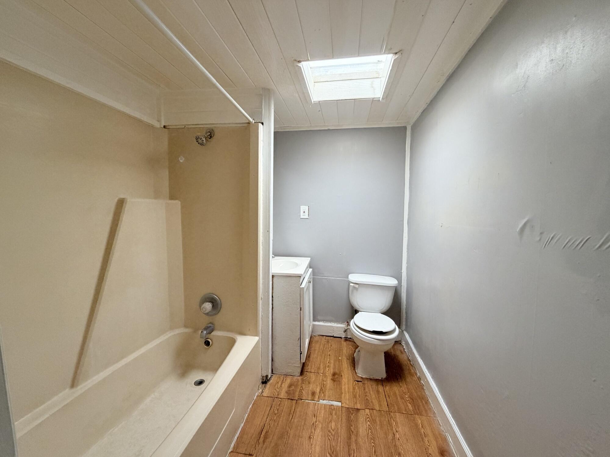 2119 15th Street Lubbock, TX 79401 - Photo 10 of 15 a bathroom with a bathtub and a toilet