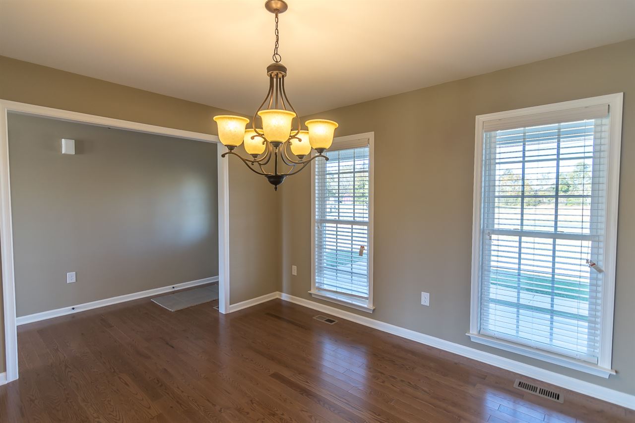 900 Riverside Avenue Grottoes, VA 24441 - Photo 11 of 37 a view of a livingroom with a chandelier wooden floor and windows