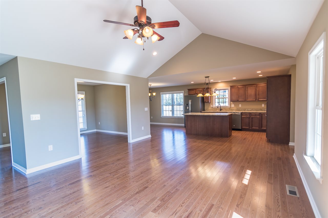 900 Riverside Avenue Grottoes, VA 24441 - Photo 12 of 37 a view of a big room with wooden floor and a kitchen