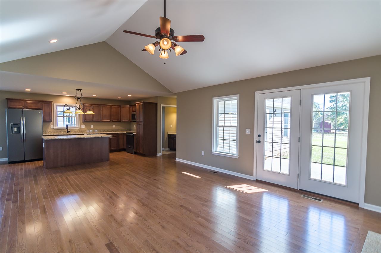 900 Riverside Avenue Grottoes, VA 24441 - Photo 13 of 37 a view of an empty room with a kitchen and wooden floor