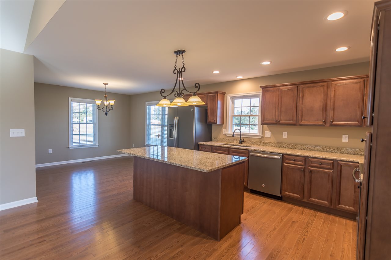 900 Riverside Avenue Grottoes, VA 24441 - Photo 15 of 37 a kitchen with stainless steel appliances granite countertop wooden floors and white cabinets
