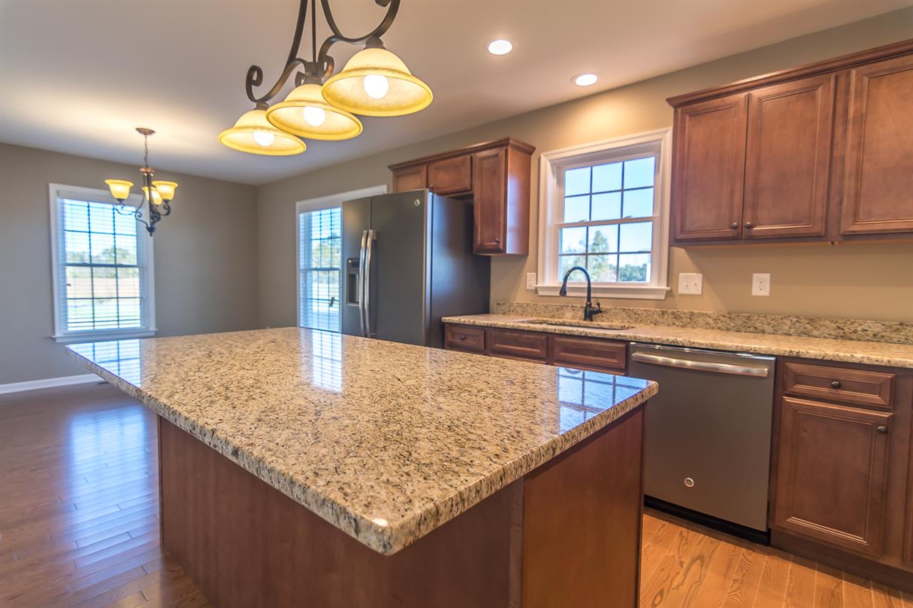 900 Riverside Avenue Grottoes, VA 24441 - Photo 16 of 37 a kitchen with kitchen island granite countertop wooden cabinets a sink a window and stainless steel appliances