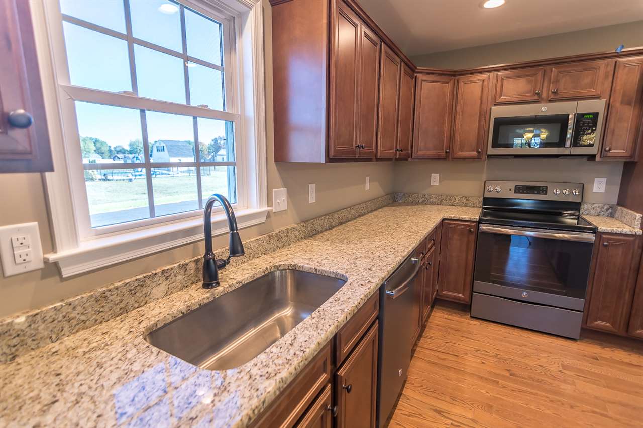 900 Riverside Avenue Grottoes, VA 24441 - Photo 17 of 37 a kitchen with kitchen island granite countertop a sink stove and microwave