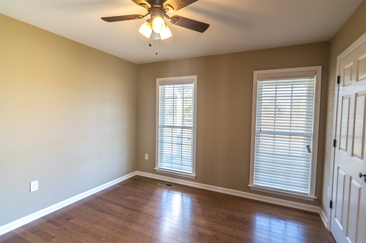 900 Riverside Avenue Grottoes, VA 24441 - Photo 25 of 37 an empty room with wooden floor and windows