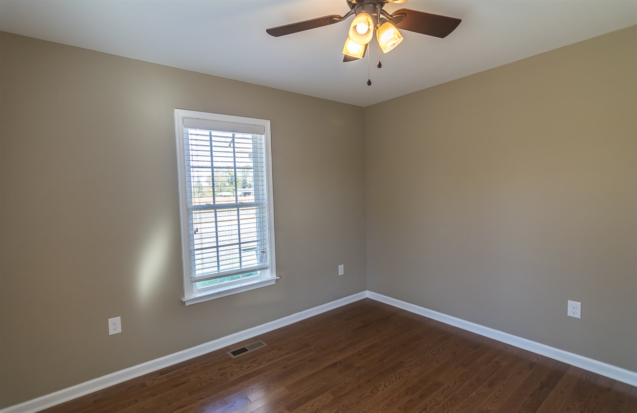 900 Riverside Avenue Grottoes, VA 24441 - Photo 27 of 37 an empty room with wooden floor and windows