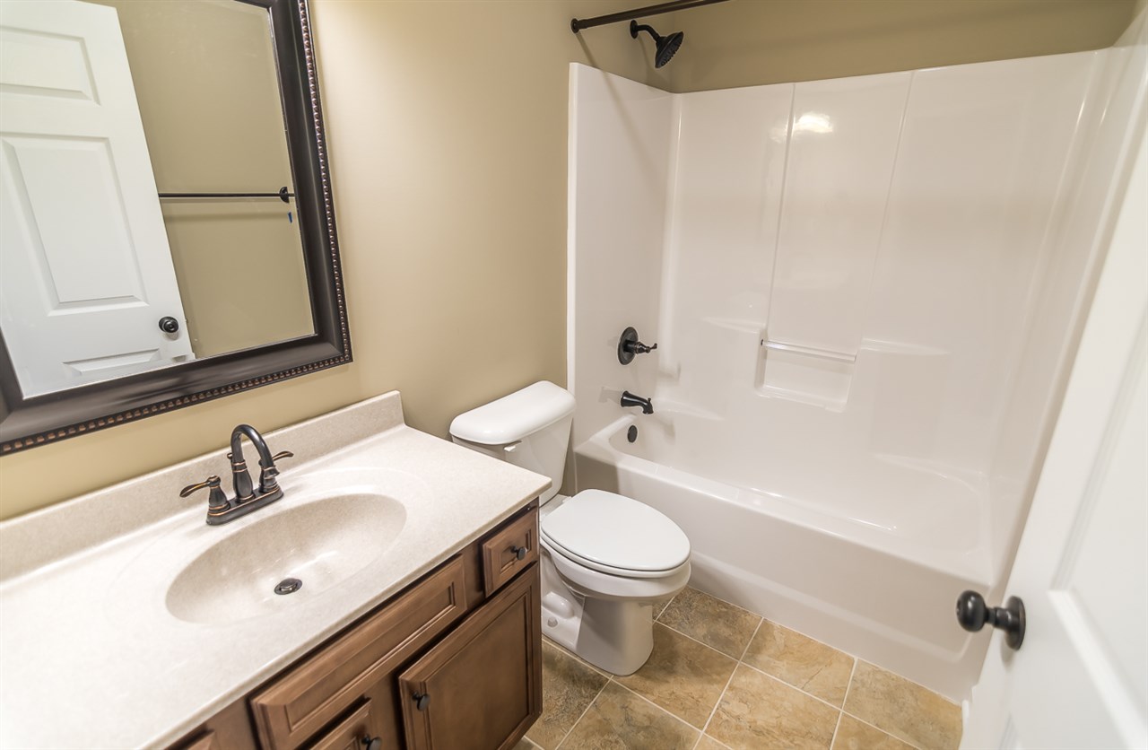 900 Riverside Avenue Grottoes, VA 24441 - Photo 29 of 37 a bathroom with a sink toilet vanity and shower