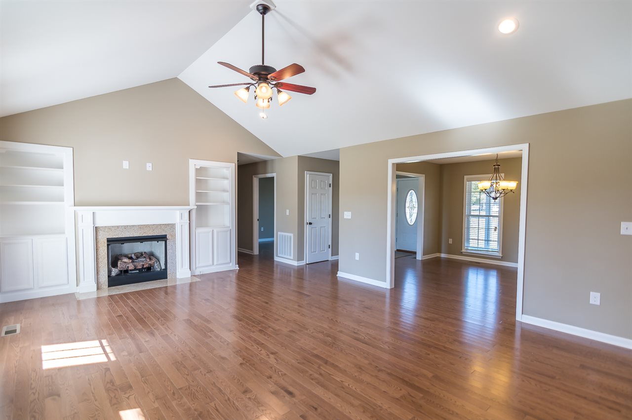 900 Riverside Avenue Grottoes, VA 24441 - Photo 5 of 37 a view of an empty room with wooden floor fireplace and a window