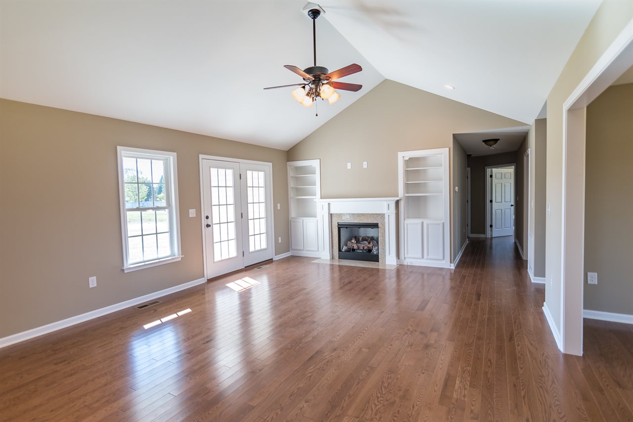 900 Riverside Avenue Grottoes, VA 24441 - Photo 6 of 37 a view of a livingroom with wooden floor a ceiling fan and windows