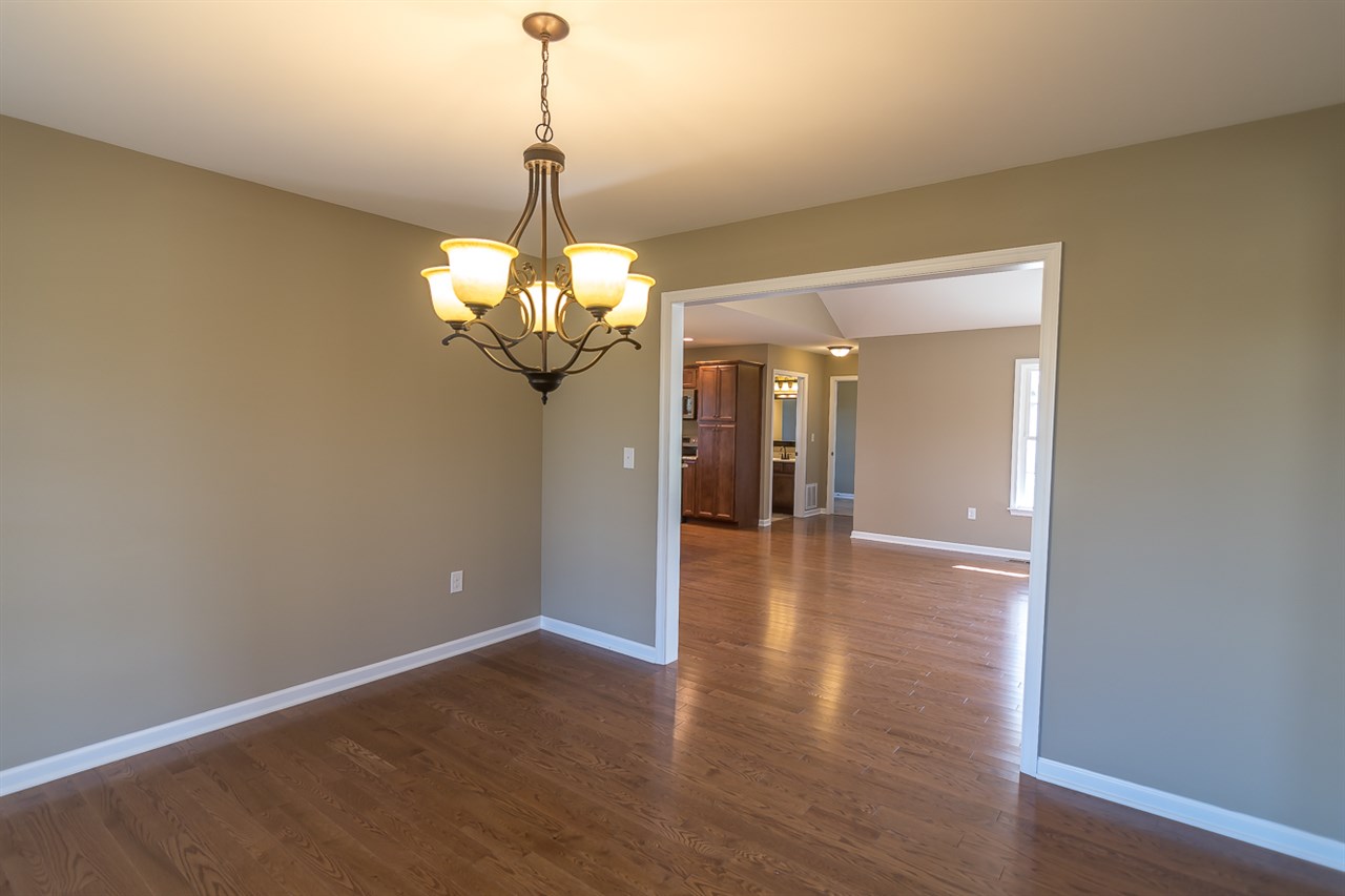 900 Riverside Avenue Grottoes, VA 24441 - Photo 9 of 37 a view of a hallway with wooden floor and a chandelier
