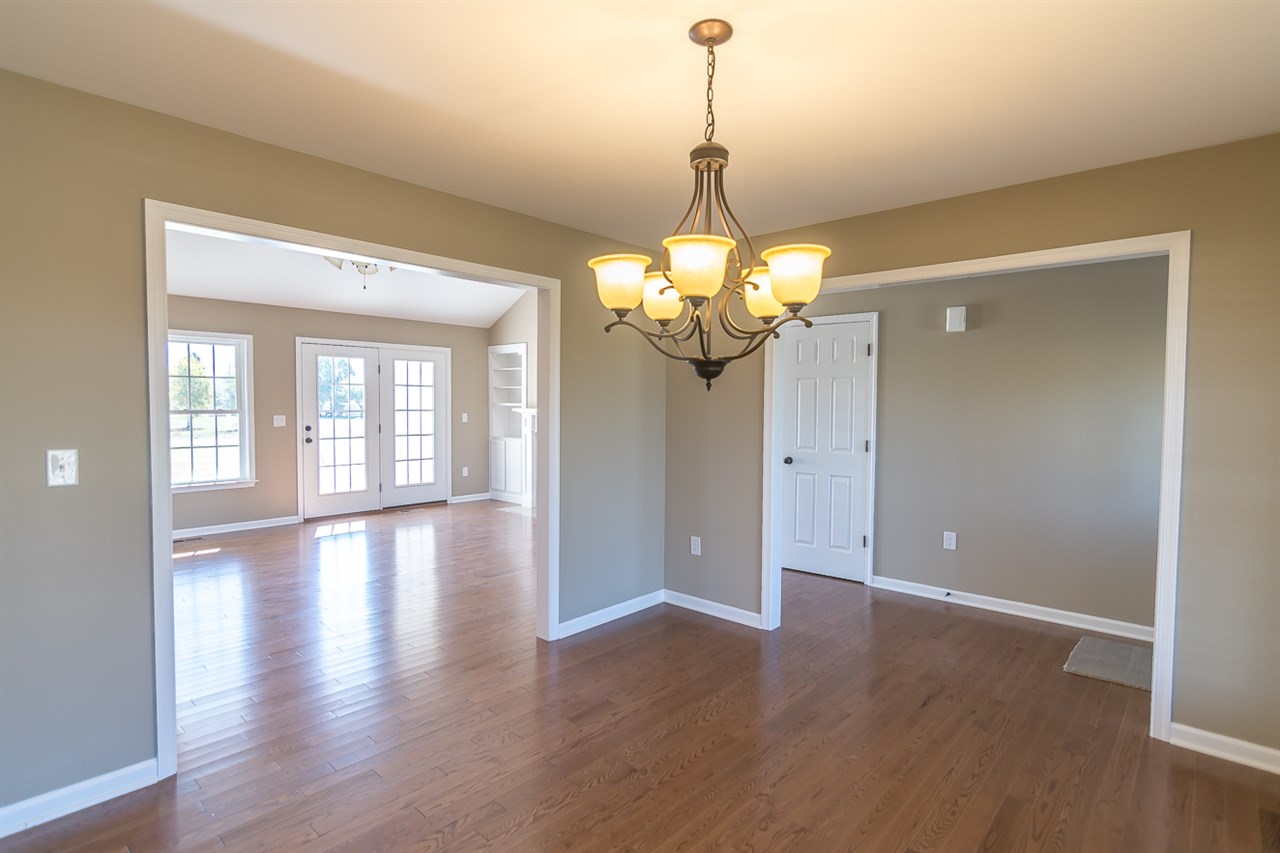 900 Riverside Avenue Grottoes, VA 24441 - Photo 10 of 37 a view of a livingroom with a chandelier wooden floor and windows