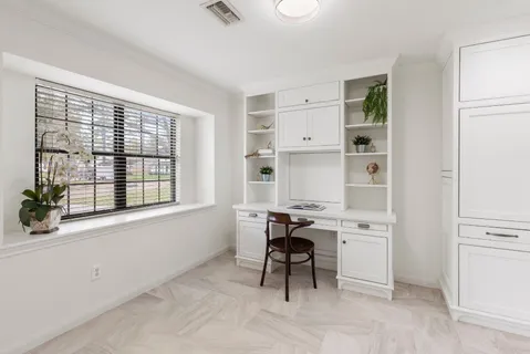 a view of a dining room and livingroom with furniture wooden floor a chandelier