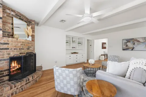 a bedroom with a bed flat screen tv and a window