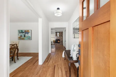 a dining room with furniture and wooden floor