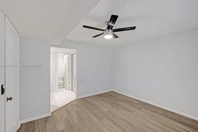 a view of a livingroom with a hardwood floor and a ceiling fan