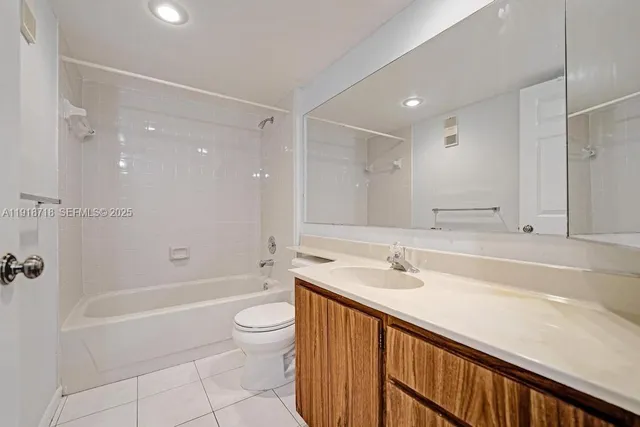 a bathroom with a bathtub shower sink and toilet