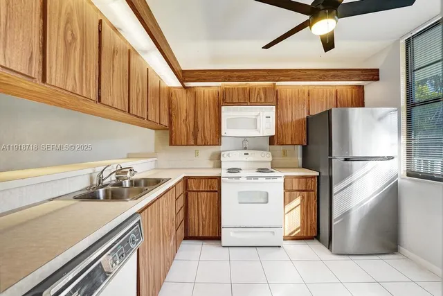 a kitchen with a refrigerator sink and cabinets