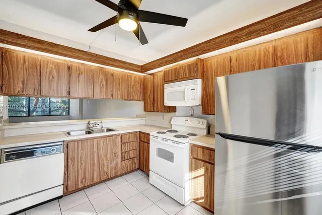 a kitchen with a stove cabinets and a refrigerator