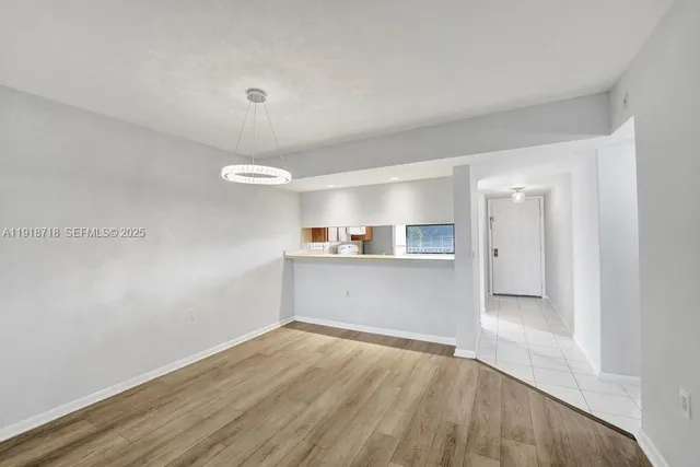 a view of a kitchen with wooden floor and a sink