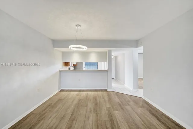 a view of a room with wooden floor and a sink