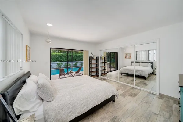 a bedroom with a bed and window