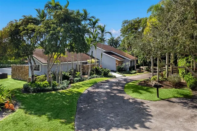 a house that has a tree in front of it