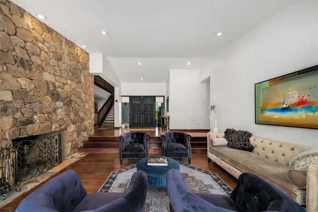 a living room with fireplace furniture and a flat screen tv