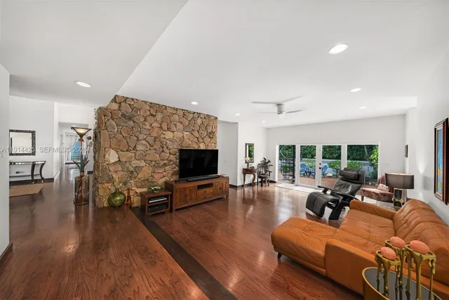 a living room with furniture flat screen tv and a fireplace