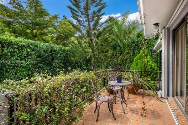 a view of a chair and tables in the balcony