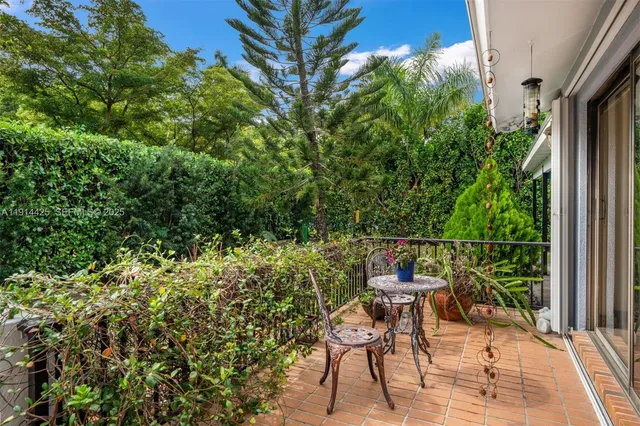 a view of a chair and tables in the balcony