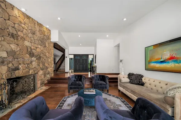 a living room with fireplace furniture and a flat screen tv