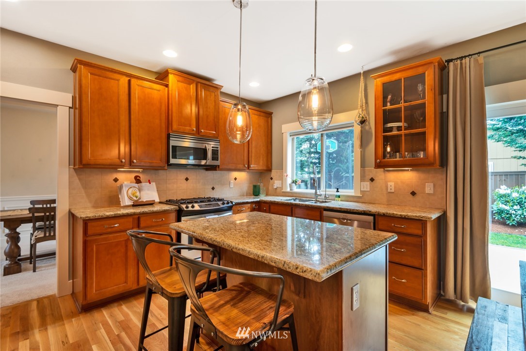 26 212th Street Southwest Bothell, WA 98021 - Photo 8 of 25 a kitchen that has a sink a table and chairs in it