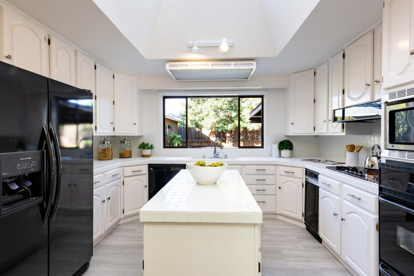 764 Parma Way Los Altos, CA 94024 - Photo 7 of 21 a kitchen with a sink stove a refrigerator and cabinets