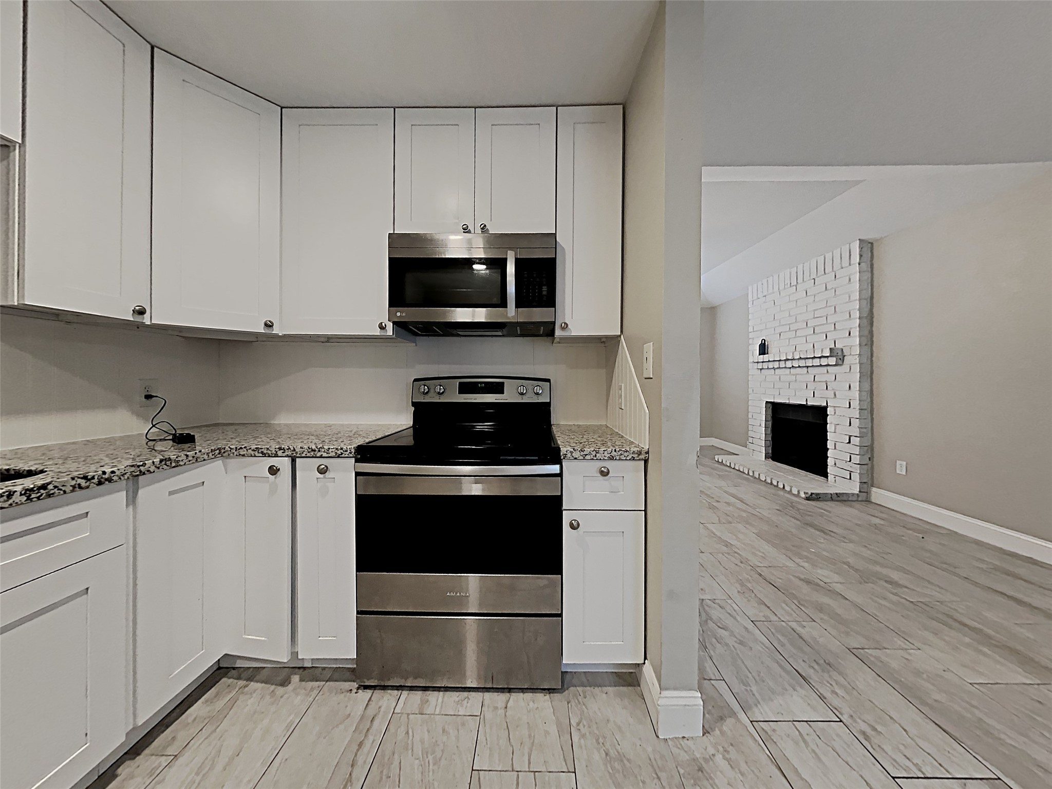 14020 Schroeder Road, Unit 108 Houston, TX 77070 - Photo 4 of 15 a kitchen with stainless steel appliances a stove a sink and a microwave