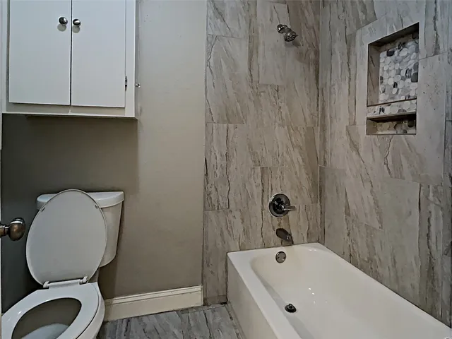 a bathroom with a toilet a sink and bathtub