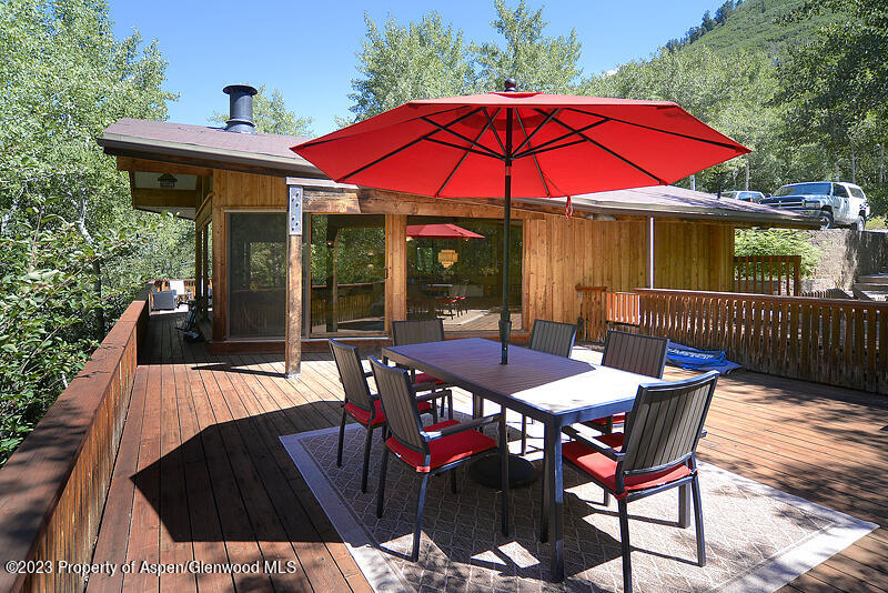 309 Mountain Laurel Drive Aspen, CO 81611 - Photo 1 of 14 a view of a patio with table and chairs under an umbrella