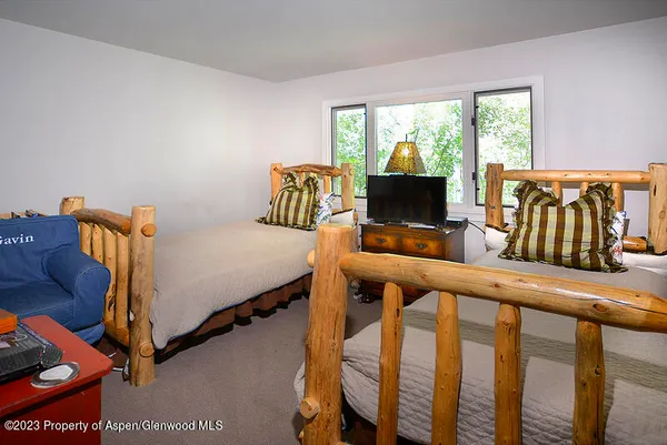 a bedroom with furniture and a flat screen tv
